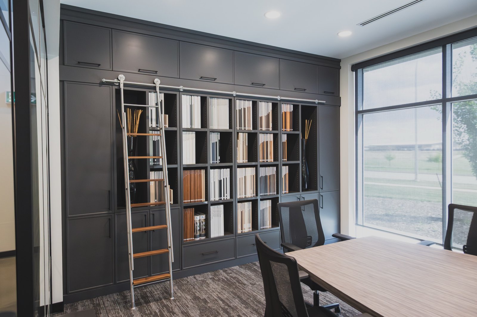Bjornson Designs showroom finish library with cabinet samples and consultation table